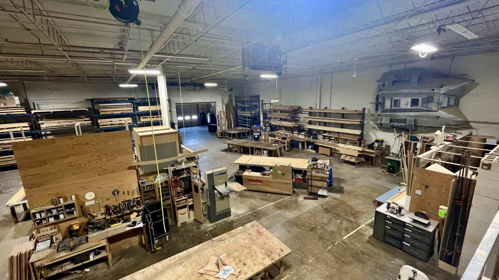 Woodworking shop with lumber, tools, and machinery.