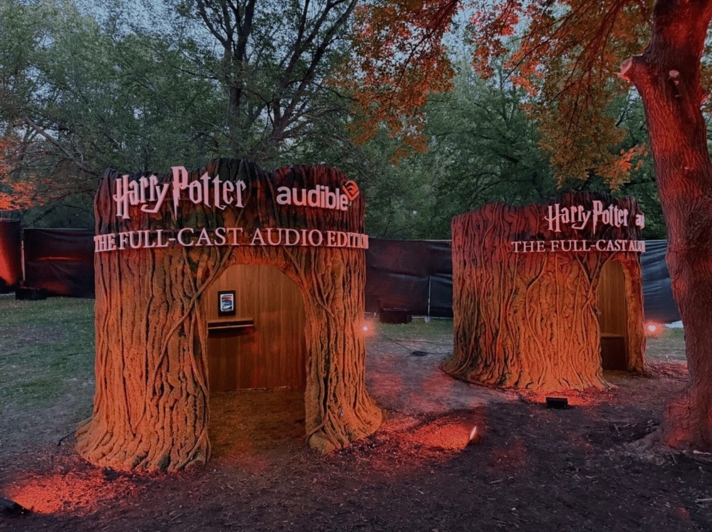 Harry Potter audiobook booths designed as tree stumps, with "Harry Potter" and "Audible" logos.
