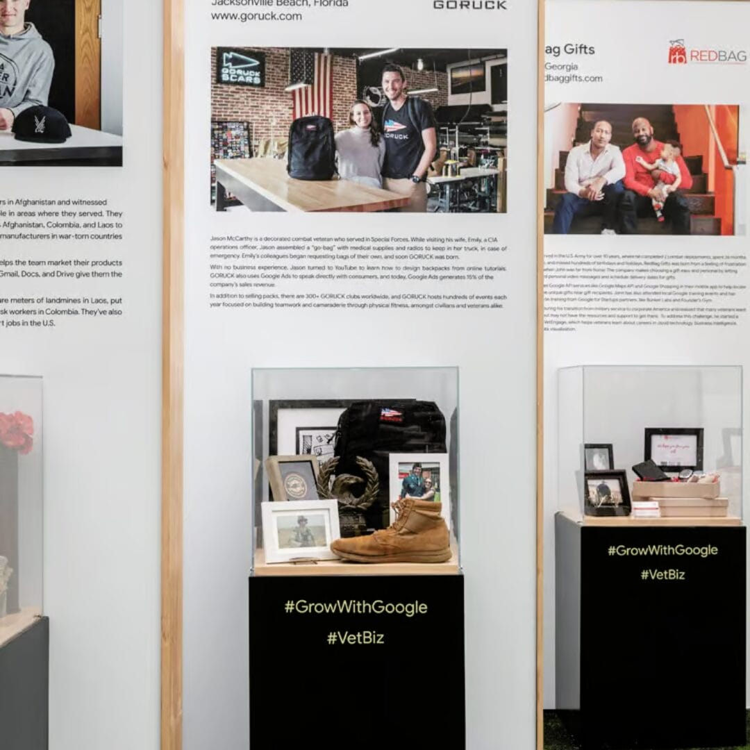Display case with GORUCK backpack, boot, and framed photos, with #GrowWithGoogle #VetBiz.