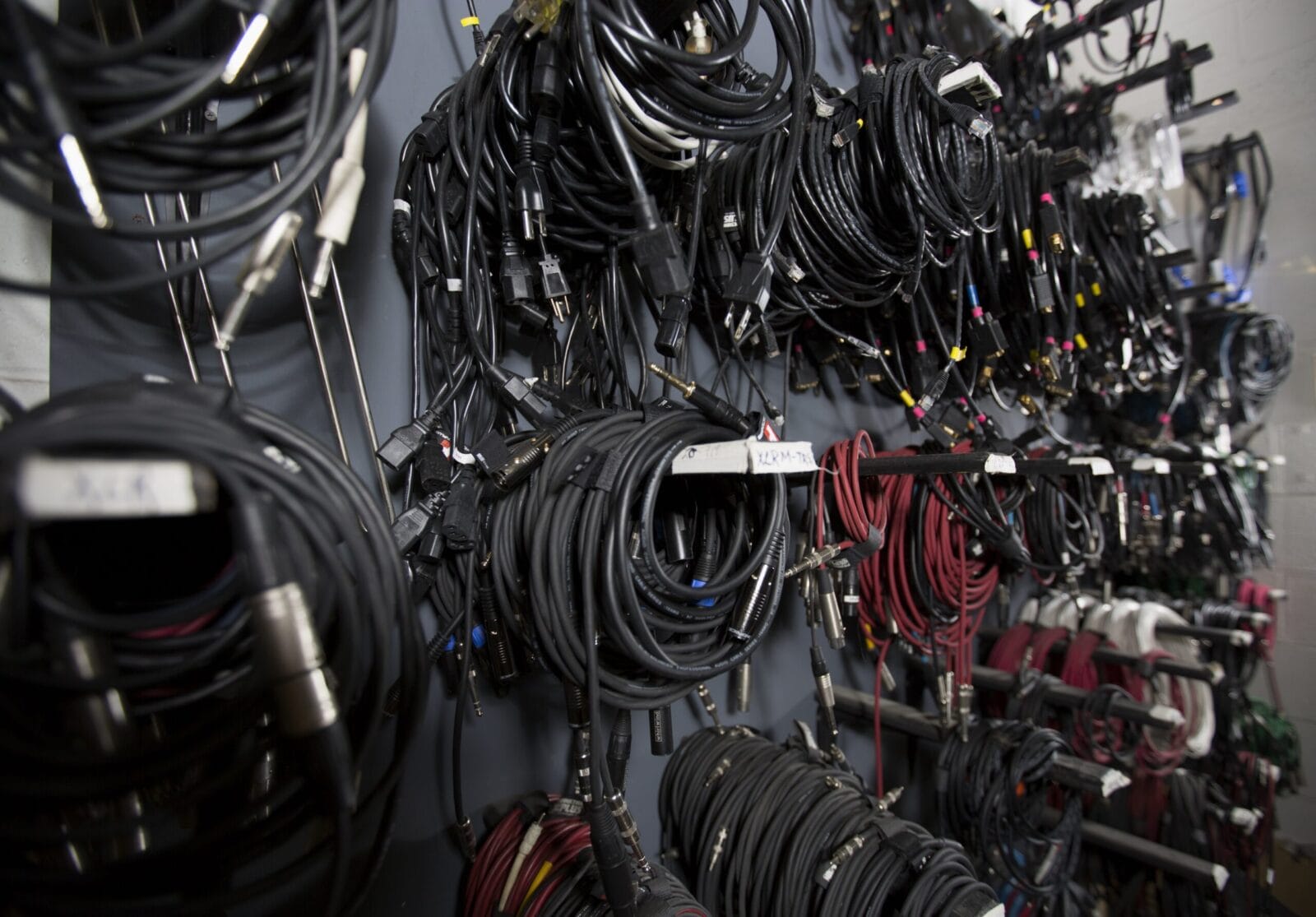 Wall of neatly organized audio and video cables.