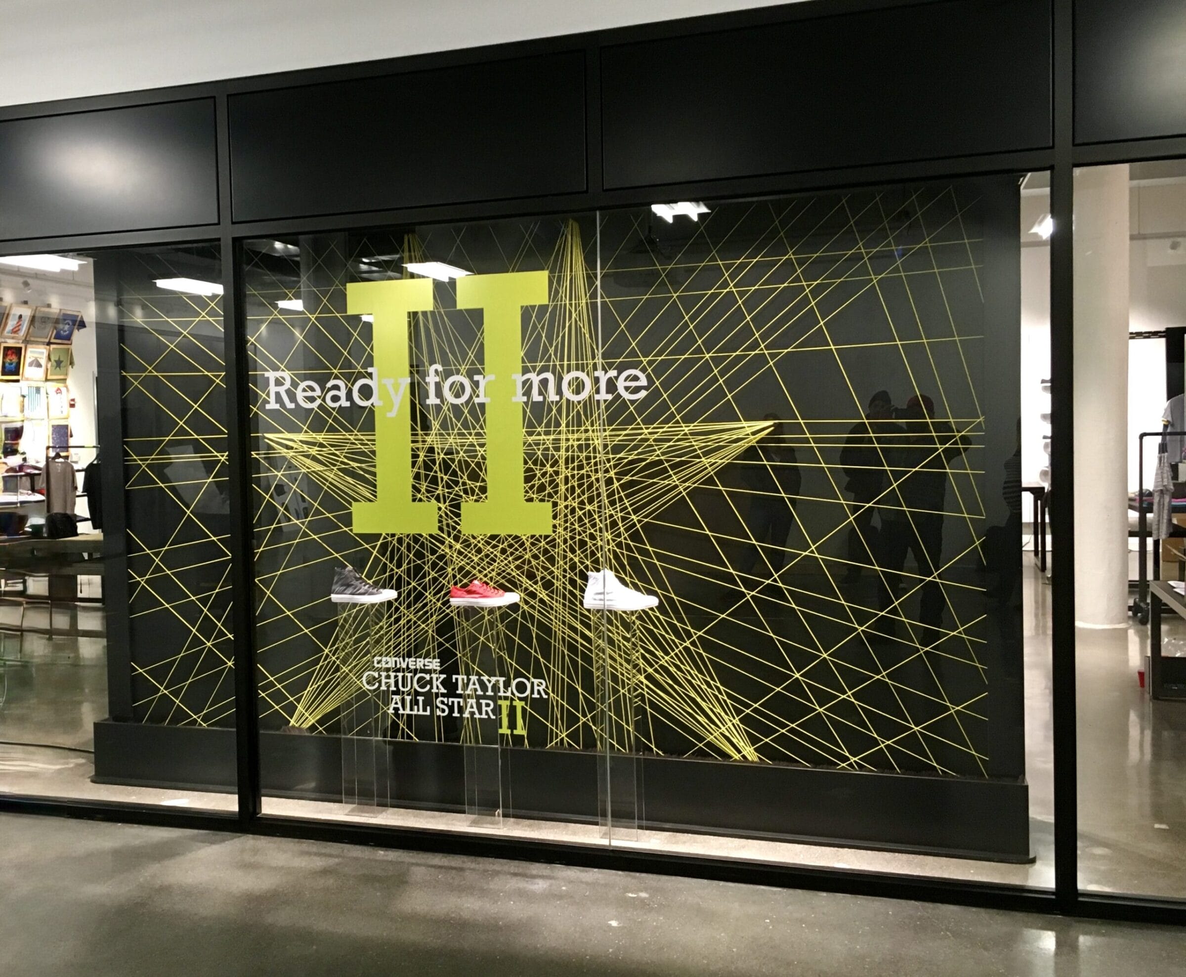 Converse Chuck Taylor All Star II display with shoes and "Ready for more" text.