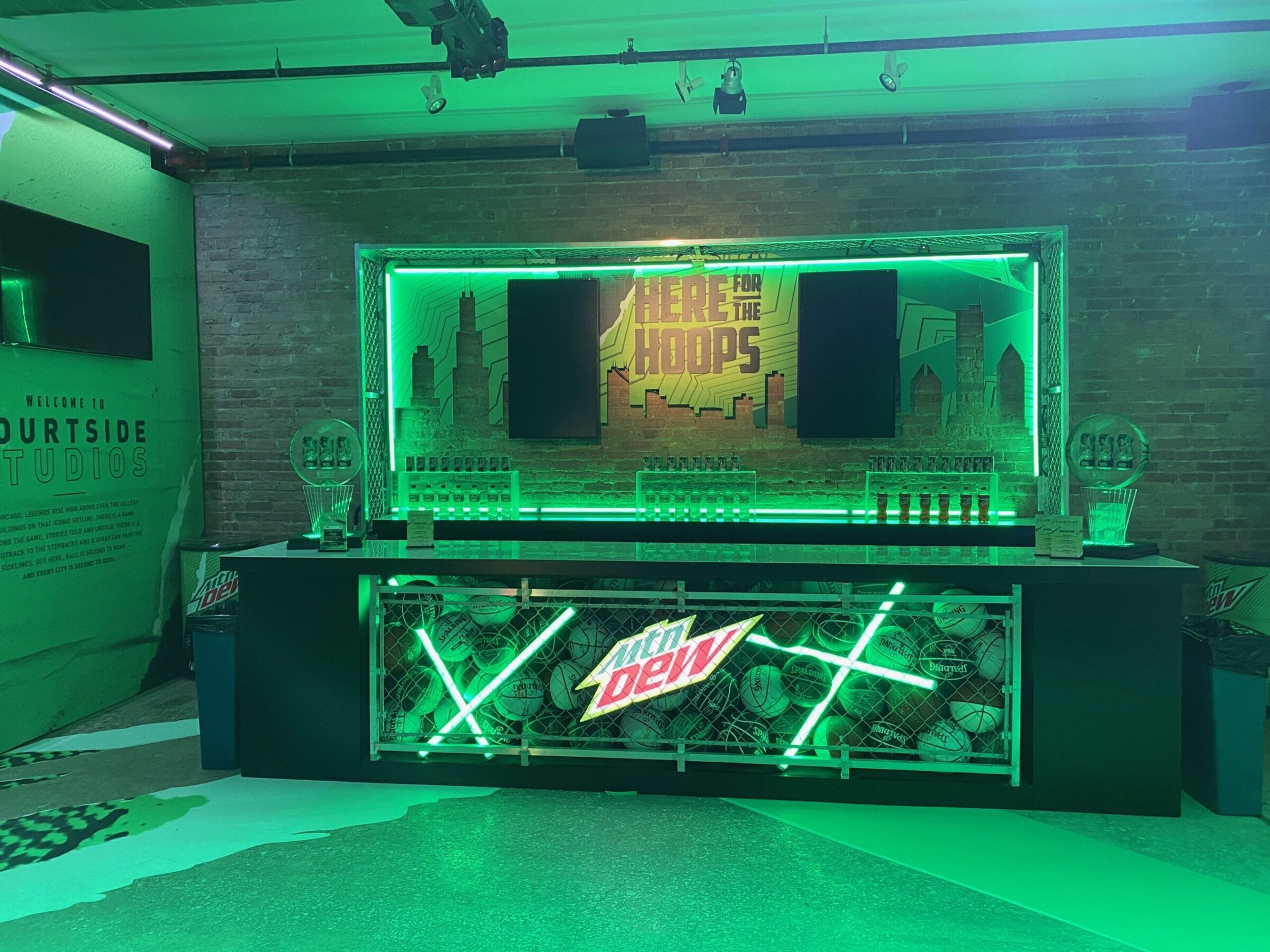 Mountain Dew bar with basketballs and neon lights.