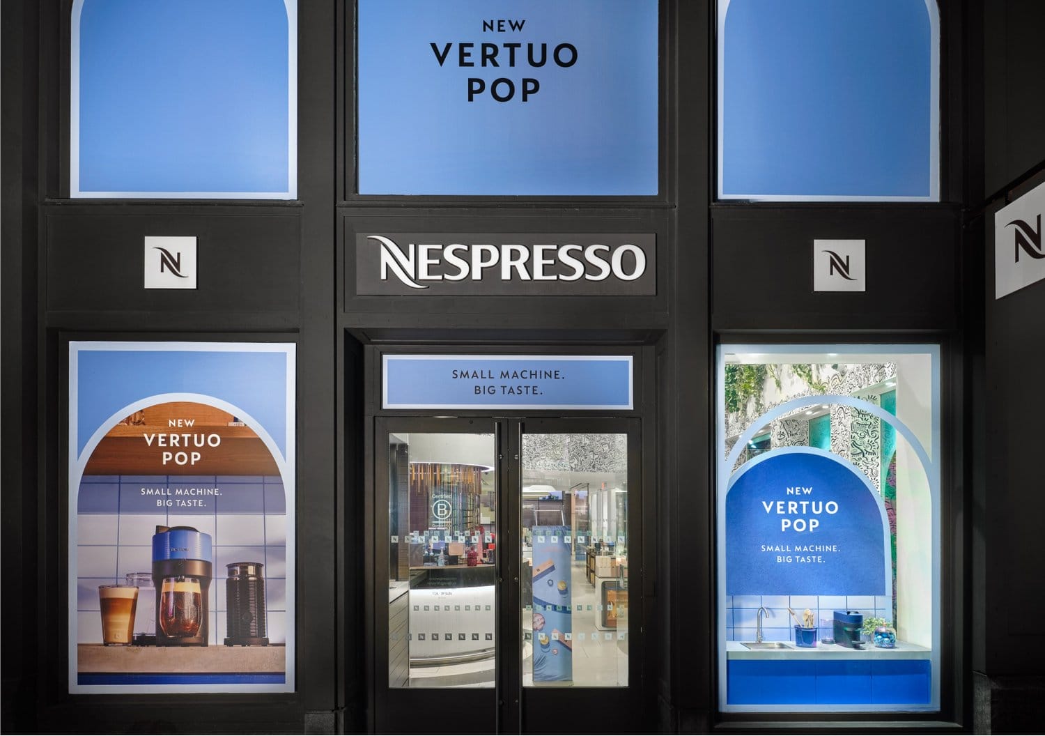 Nespresso store facade with "New Vertuo Pop" signage and coffee machine display.